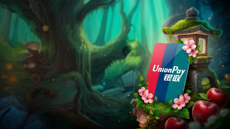 UnionPay logo on a payment card propped against a stone lantern among pink blossoms